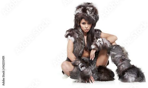 Fotografi beautiful woman in barbarian costume at white background