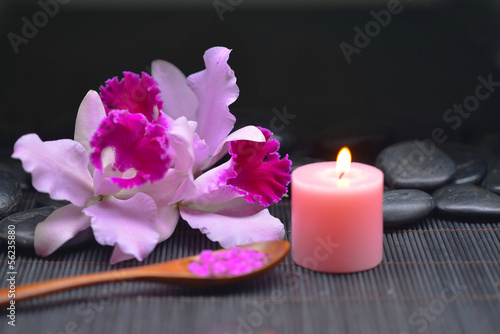 Beautiful pink orchid and stones ,candle, salt in bowl on mat