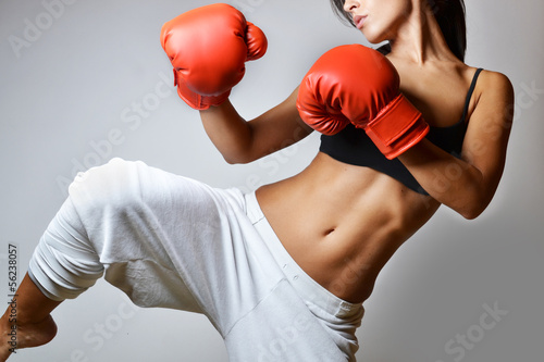 Obraz na plátně beautiful woman with the red boxing gloves, studio shot