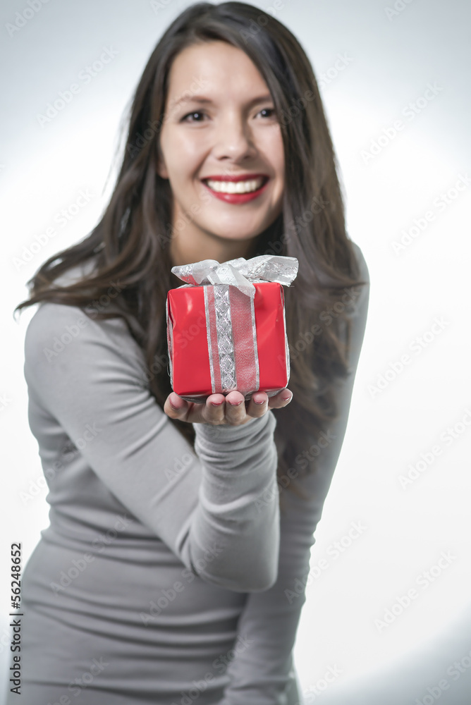 Pretty woman holding out a gift Pretty woman holding out a gift