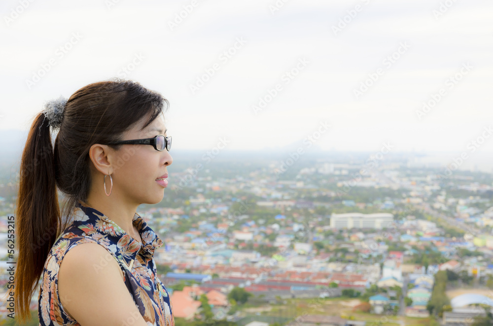 Women look at a view of the city from on high. Women look at a view of the city from on high.