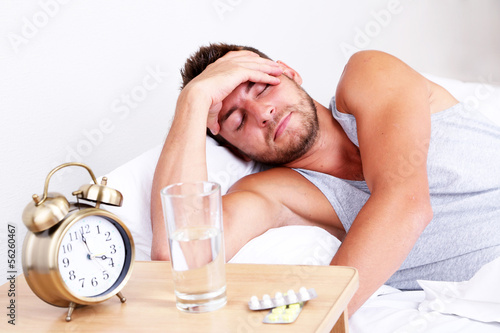 Handsome young man in bed