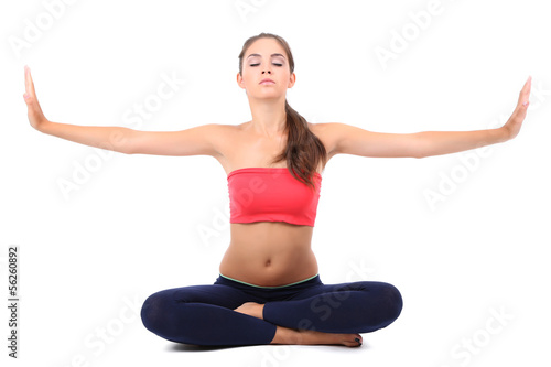 Young beautiful fitness girl doing yoga exercise isolated