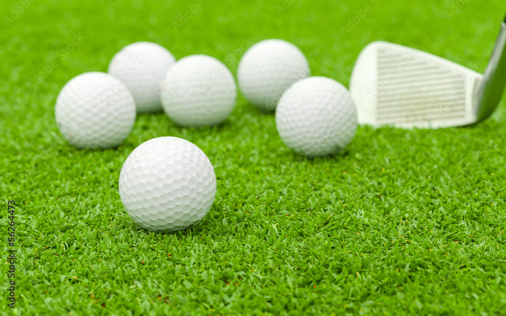 golf ball on tee in front of driver green course golf ball on tee in front of driver green course