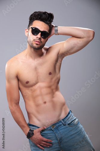 topless man posing with hand behind head