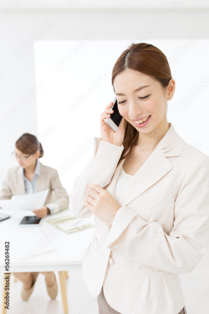 Beautiful asian businesswomen using a cellular Beautiful asian businesswomen using a cellular