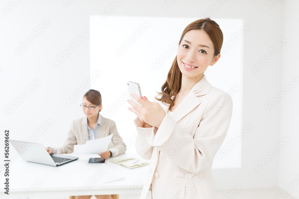 Beautiful asian businesswomen using a cellular Beautiful asian businesswomen using a cellular