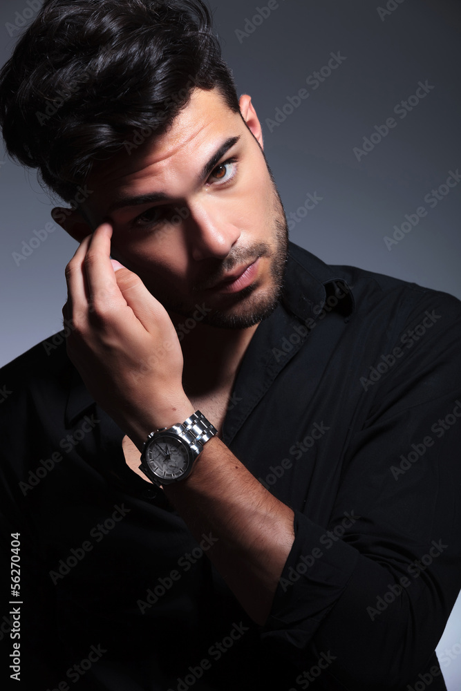 young fashion man scratching eyebrow young fashion man scratching eyebrow