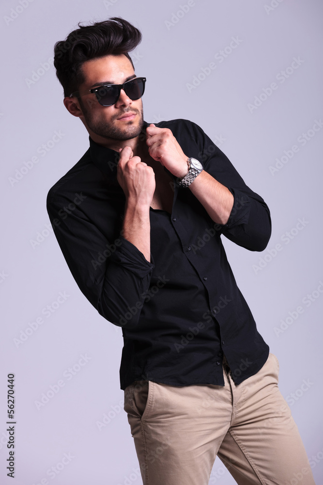 Fototapeta premium young fashion man fixing his shirt
