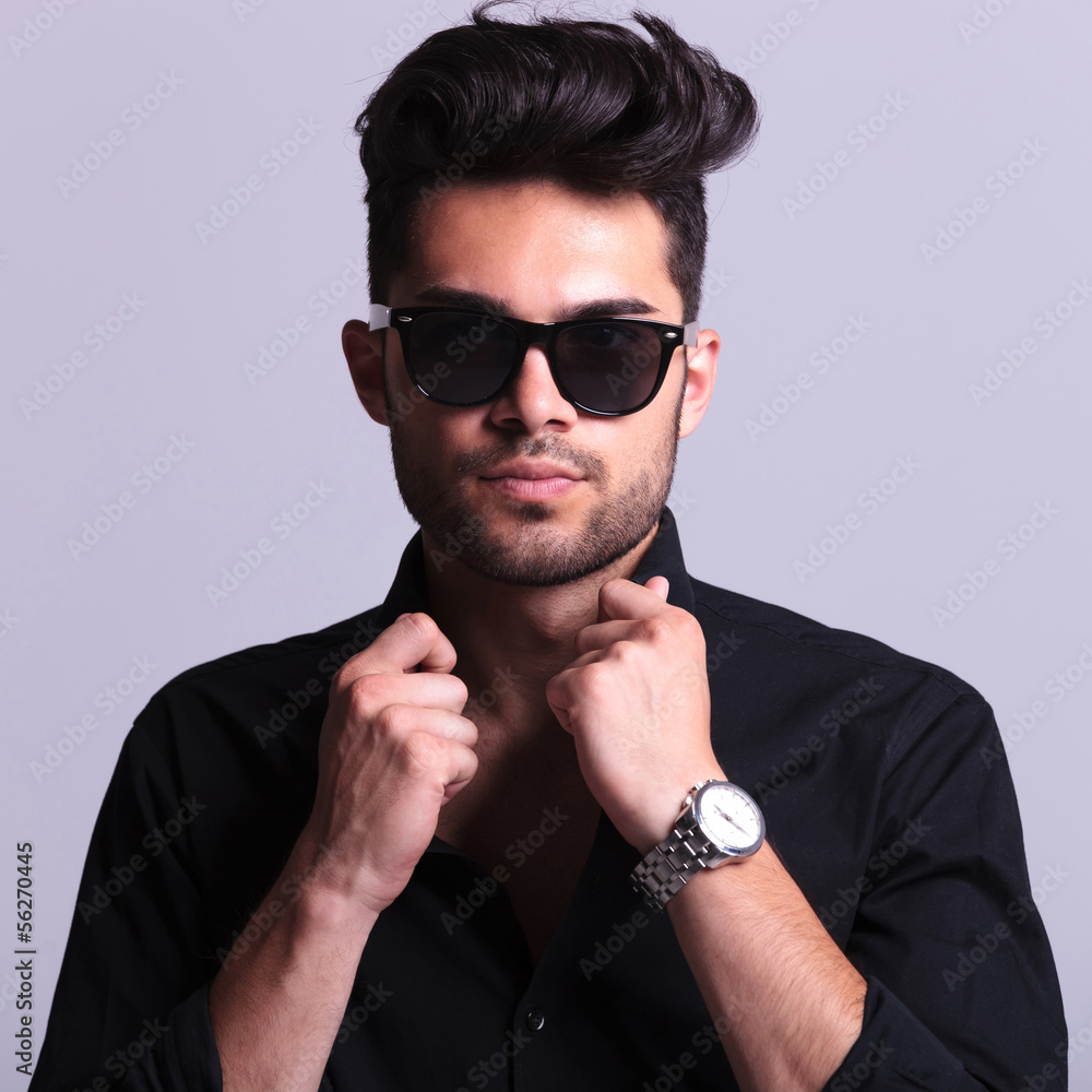 Obraz premium young fashion man with hands on collar