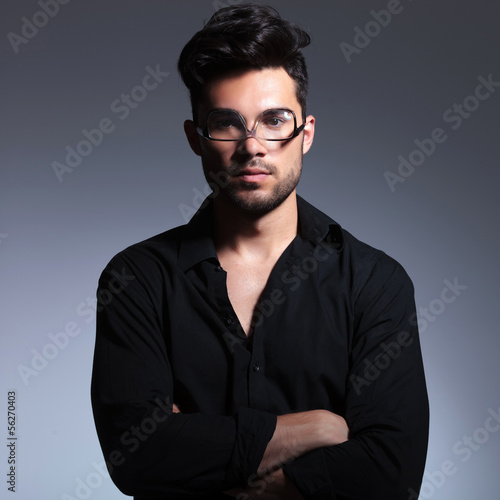 young fashion man holds glasses upside down