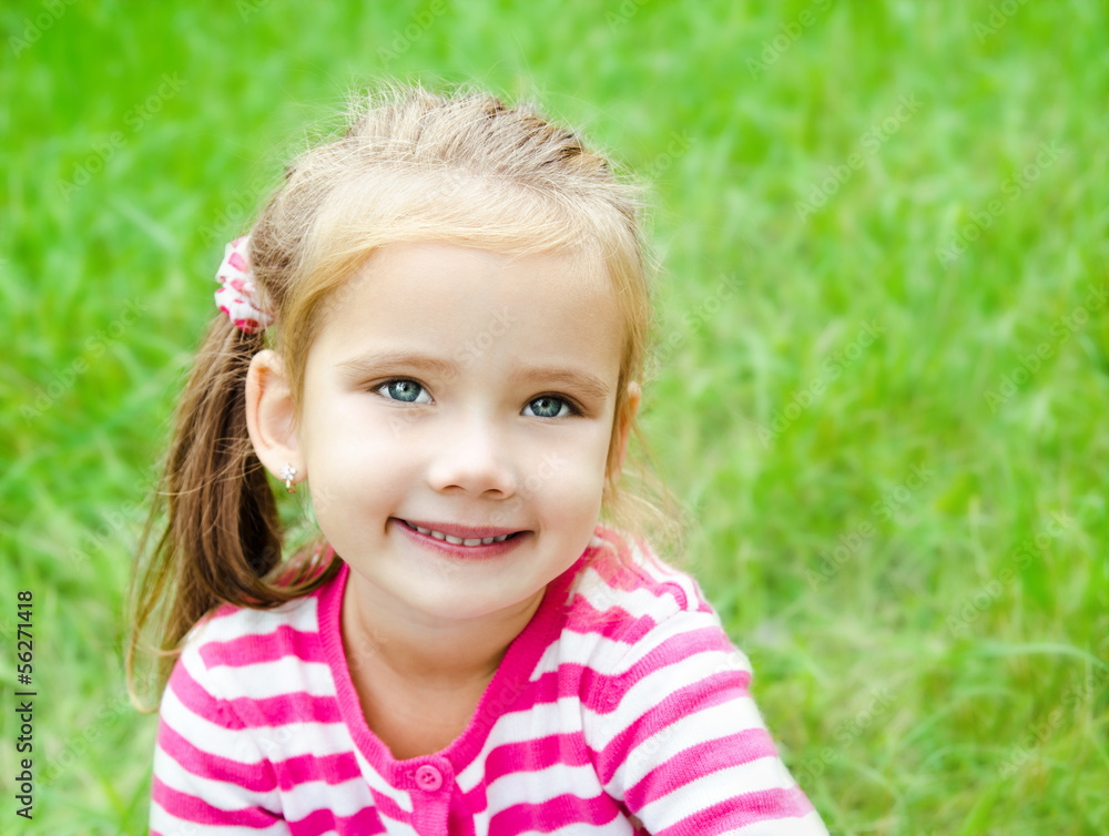 Portrait of cute smiling little girl on the meadow Portrait of cute smiling little girl on the meadow