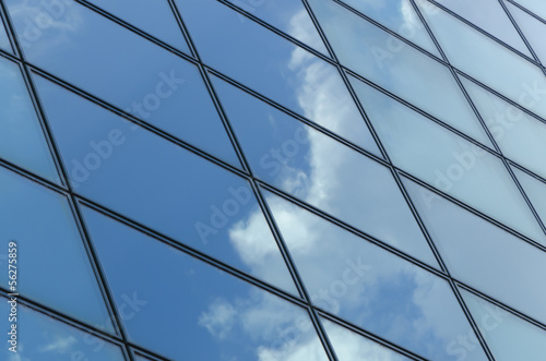 glass surface of a building with reflection of a cloud