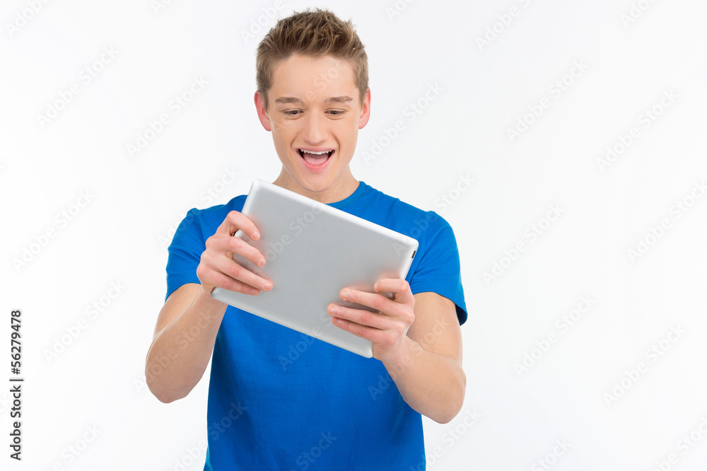 Young gamer. Cheerful teenage boy playing video games at his dig Young gamer. Cheerful teenage boy playing video games at his dig