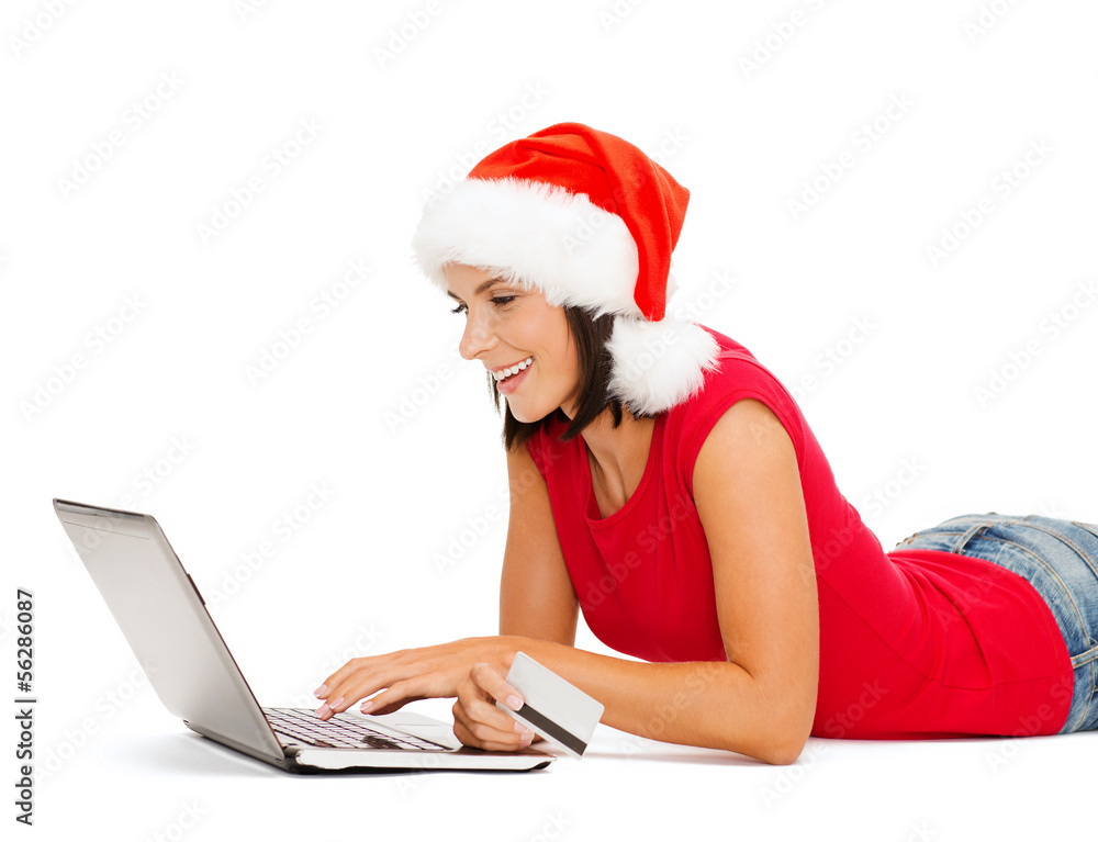 woman in santa hat with laptop and credit card