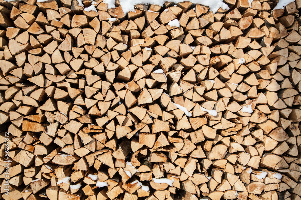 pile of firewood. snowy firewoods in winter forest pile of firewood. snowy firewoods in winter forest