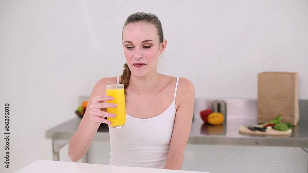 Smiling model drinking glass of orange juice Smiling model drinking glass of orange juice