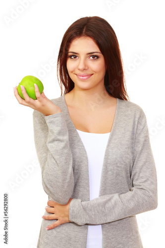 Beautiful happy woman holding an apple over white background