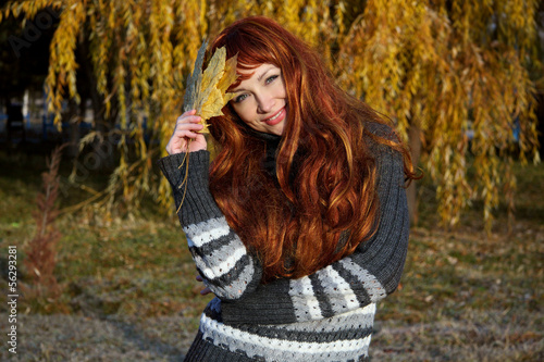 girl with red hair, in autumn park.