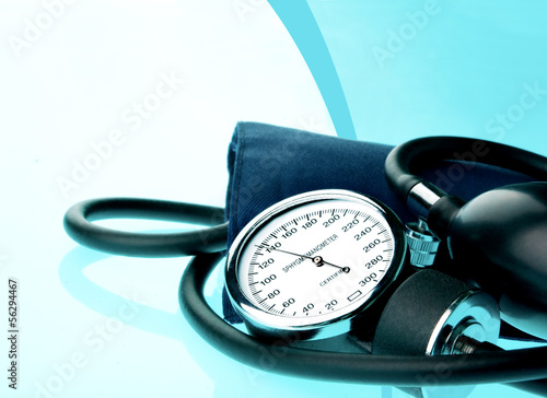Sphygmomanometer on blue, reflective background