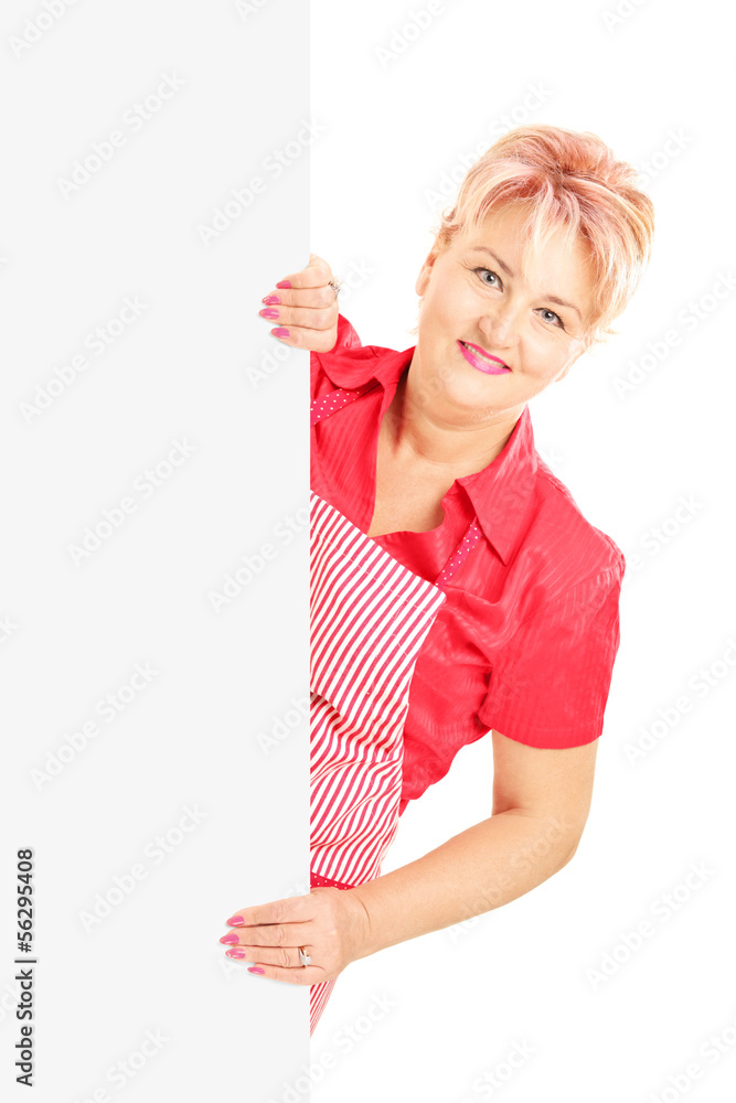 Blond smiling woman wearing an apron and holding a panel Blond smiling woman wearing an apron and holding a panel