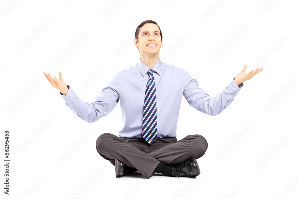 Young businessman sitting on a floor and gesturing with his hand Young businessman sitting on a floor and gesturing with his hand