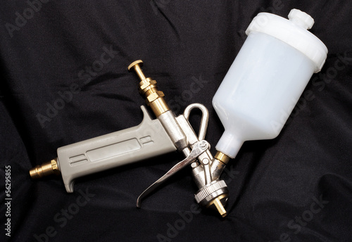 spray paint gun on black background photo