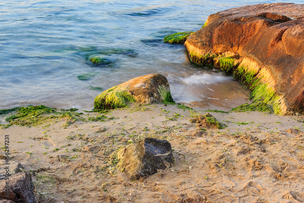 sea wave strugle with stone on the sandy beach