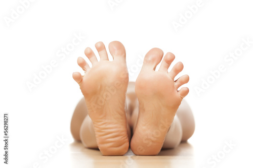 naked woman lying on the floor with a focus on feet