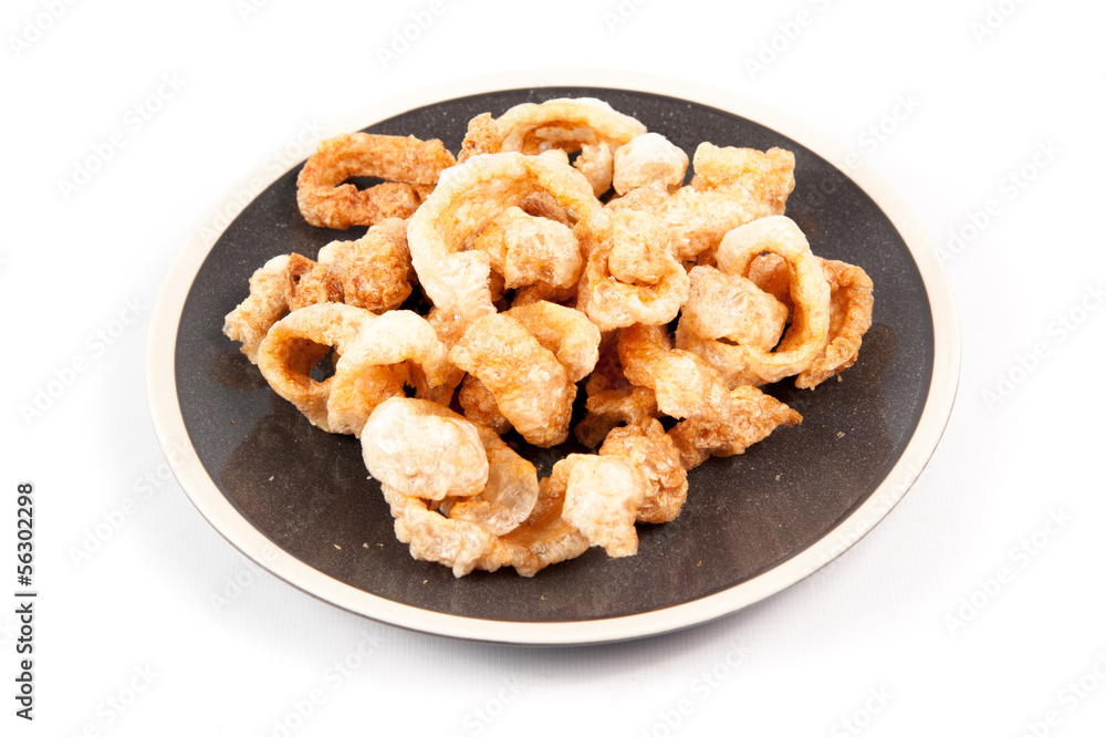 Fried pork rinds over a white background Fried pork rinds over a white background