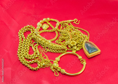 gold necklace red background