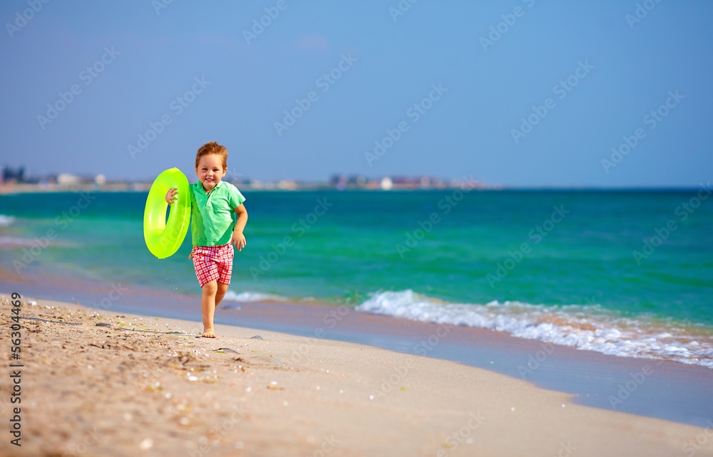 happy boy running the beach surf, expressing delight happy boy running the beach surf, expressing delight