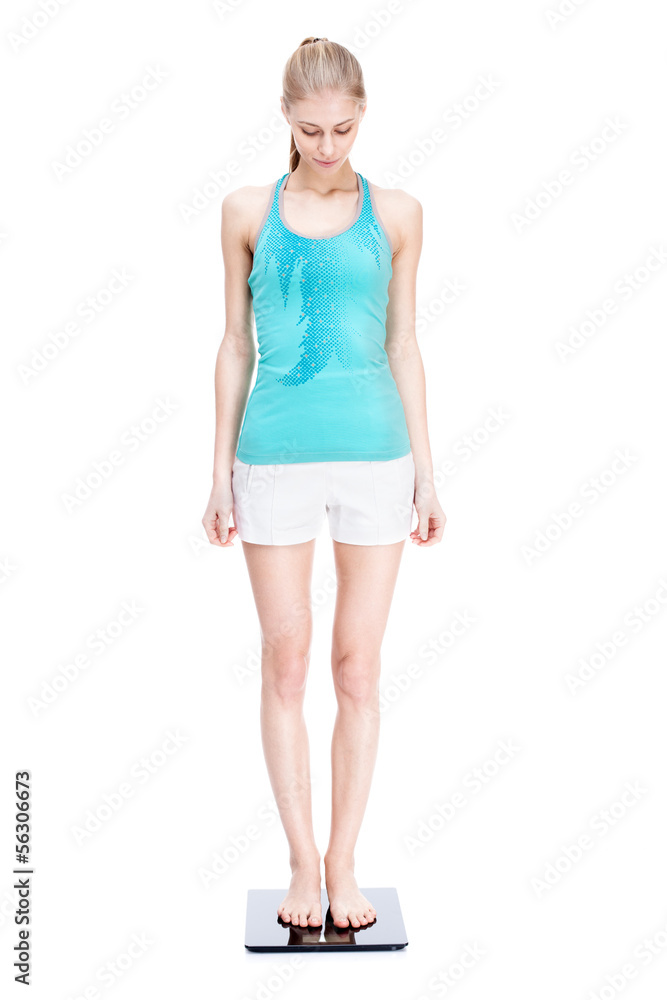 young blond woman standing on scales young blond woman standing on scales