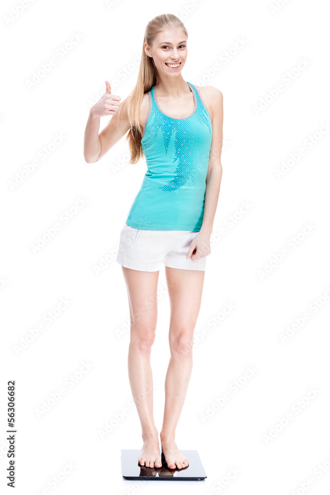 Fototapeta premium young blond woman standing on scales