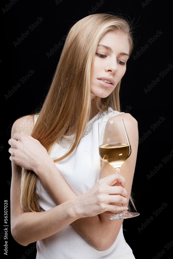 young blond woman holding glass of white wine young blond woman holding glass of white wine