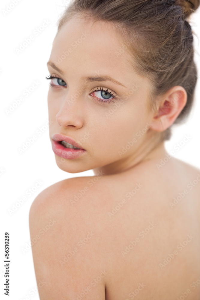 Thinking brunette model posing looking over her shoulder Thinking brunette model posing looking over her shoulder