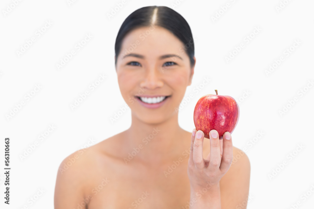 Smiling natural brunette holding red apple Smiling natural brunette holding red apple