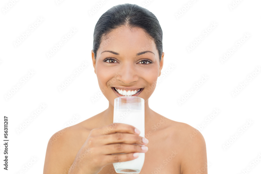 Cheerful black haired model holding glass of milk Cheerful black haired model holding glass of milk