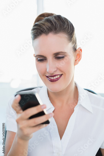 Close up view on smiling businesswoman using smartphone