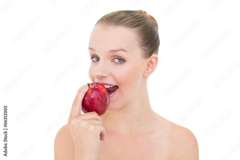 Amused pretty blonde model eating an apple Amused pretty blonde model eating an apple