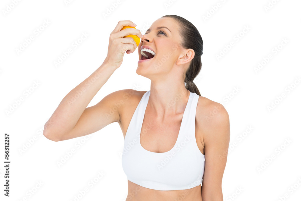 Sporty woman drinking juice from orange Sporty woman drinking juice from orange