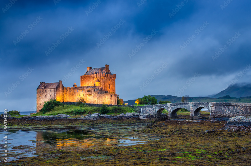 View of Eilean Donan castle at sunset in Scottish highlands View of Eilean Donan castle at sunset in Scottish highlands