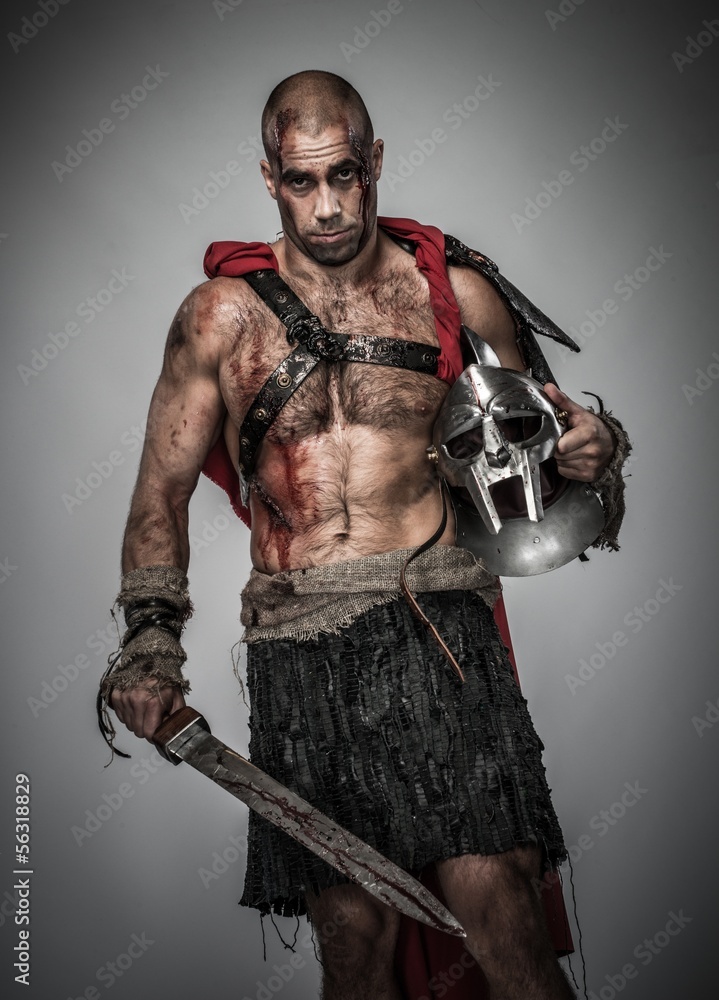 Wounded gladiator with sword covered in blood Wounded gladiator with sword covered in blood