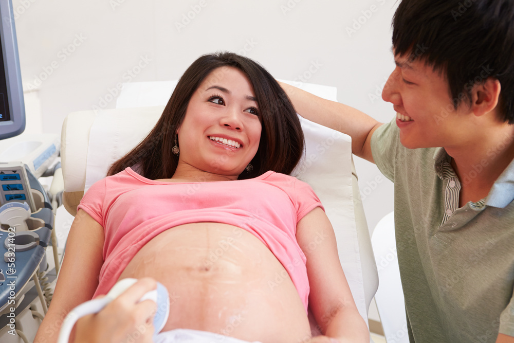 Fototapeta premium Pregnant Woman And Partner Having 4D Ultrasound Scan