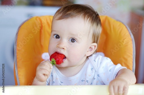nice baby age of 1 year eats strawberry