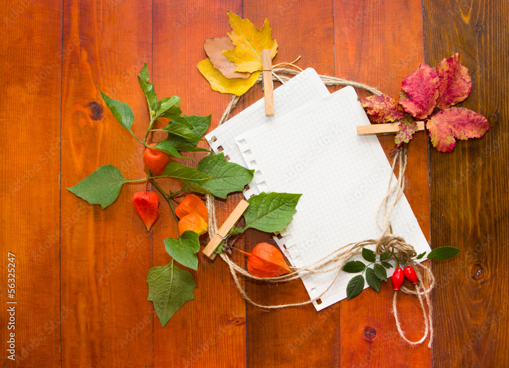 Autumn leaves with white paper for text.
