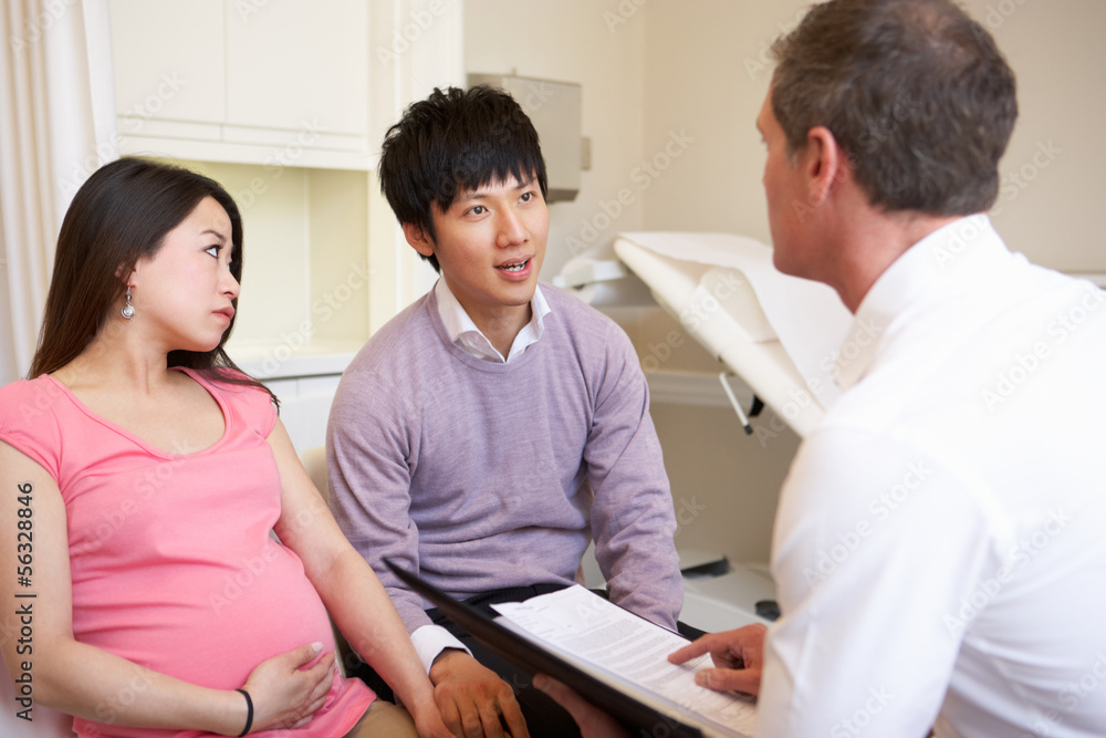 Fototapeta premium Couple Meeting With Obstetrician In Clinic