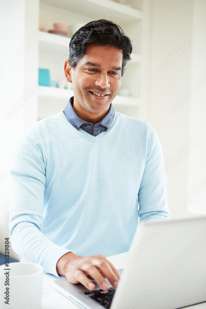 Fototapeta premium Indian Man Using Laptop At Home