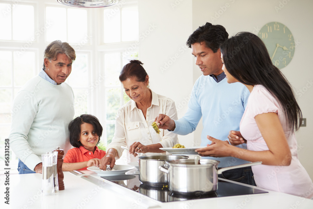 Multi Generation Indian Family Cooking Meal At Home