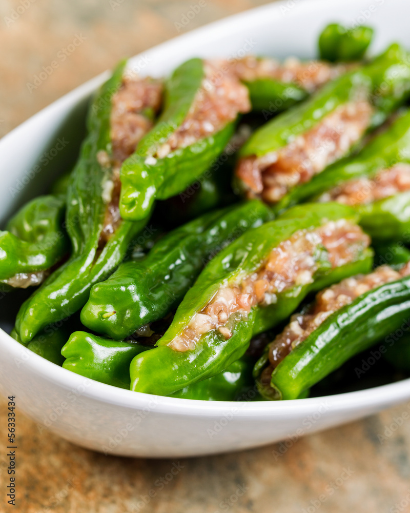 Uncooked Fresh Stuffed Green Peppers in bowl ready for cooking Uncooked Fresh Stuffed Green Peppers in bowl ready for cooking